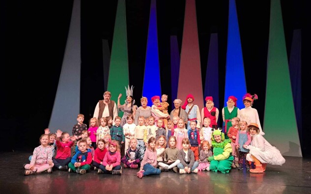 Dzieci z przedszkola nr 54 w Lublinie pozują na scenie do zdjęcia wspólnie z aktorami bajki muzycznej 